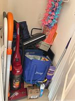 Full view of lot showing vacuum, step stool, scanner, bags, and cleaning supplies in a small room.