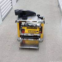 Front view of DeWalt benchtop thickness planer on concrete floor