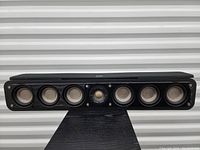 Front view with drivers exposed: six 3-inch woofers and central 1-inch dome tweeter.