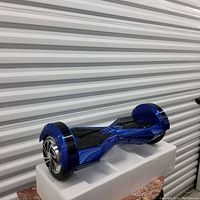 Blue self balance scooter (hoverboard) angled view showing wheels and footpads.