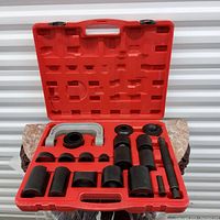 Universal ball joint tool set with red plastic carrying case opened, showing the organized black metal tools for ball joint service.