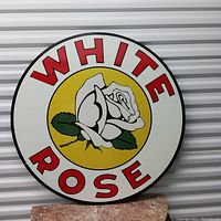 Clear, front-facing photo of the circular White Rose Motor Oil metal sign showing the full design and colors.