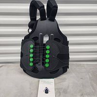 Front view of adjustable full back brace showing padded shoulder straps and lace adjustment system.