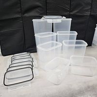 Photo showing all 8 clear plastic storage containers with snap-lock lids placed in front. Lids are off to the side showing black airtight gaskets and locking tabs.