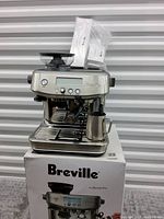 Front view of the espresso machine on original box
