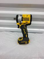 Single photo of a yellow and black DeWalt cordless impact wrench displaying the side view, showing model and branding clearly.
