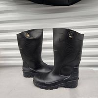 Side view of both black Dunlop rubber boots showing logos and pull holes.