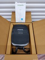 Charger unit and manual placed in shipping box