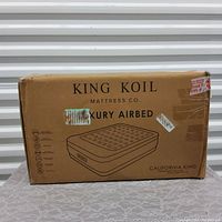 Boxed King Koil Luxury Airbed in California King size with product details and graphics visible on cardboard packaging.