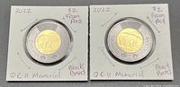 Two 2022 Canadian $2 Memorial coins packaged in individual white card holders with clear window, showing both sides of each coin and handwritten annotations.