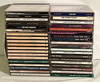 Photos showing the spines of the CDs in the collection illustrating various artists and titles mainly classic rock and classical music.