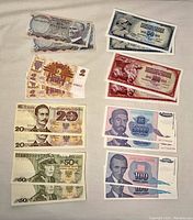 Full overview of all the paper currency from multiple European countries including Turkey, Latvia, Poland, and Yugoslavia shown together on a flat surface.