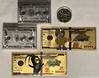 Top view showing two silver foil Bitcoin playing cards, one gold foil coin, and two SpongeBob SquarePants gold foil novelty bills.