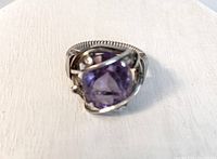 Front view showing faceted cushion-cut purple amethyst set in decorative 10k gold wire setting.