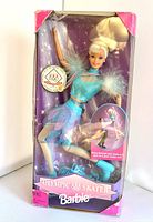 Front view of the Barbie doll in original box showing turquoise and purple ice-skating outfit and wear to packaging corners