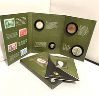 Photo of the open green folder displaying the 2014 FDR Presidential $1 coin, dime, silver medal, bronze medal, and the booklet on Roosevelt’s life and presidency.