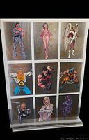 Front view showing all nine Marvel Universe trading cards featuring characters Scalphunter, Psylocke, Angel, Giant-Man, Wonder Man, Wolverine, Nova, Emma, and Galactus housed in a clear plastic sheet within an acrylic stand.