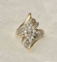 Top view of ring showing central diamond cluster and flared diamond-accented shoulders