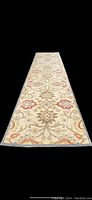 Full length view of Surya Indian wool runner rug showing floral pattern and overall condition