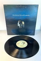 Front cover of The Doors The Soft Parade vinyl LP with record on display, showing wear marks on cover.