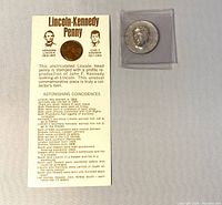 1973 Lincoln Penny in mounting paper with printed Lincoln-Kennedy coincidental facts