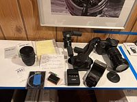 Overview of camera body, lenses, flash, charger, batteries, case, manuals, and stabilizer
