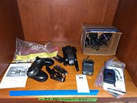 Overview of lot showing drone, controller, transceivers, USB chargers, manuals, and plastic bag with label.
