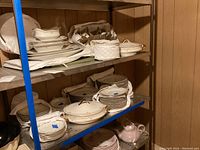 Image showing approx 80 pieces of white Haviland Limoges china arranged on two shelves including plates and covered casseroles.