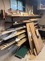 Six shelves filled with assorted exotic and scrap wood boards and blocks stacked in various sizes.