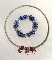 Blue bead bracelet with alternating clear and patterned blue beads, shown on white background
