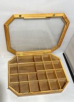 Open view showing inside of wooden shadowbox with multiple small compartments