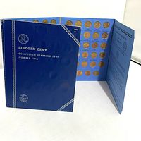 Opened view showing gold-colored coin slots filled with Lincoln pennies from 1941 to 1974