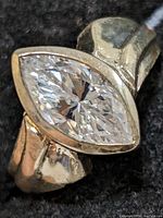 Close-up photo of the marquise-cut cubic zirconia on silver ring with sculpted band detailing