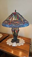 Full lamp front view showing stained glass shade with dragonfly design