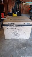 Box of Sears Craftsman 10 inch compound miter saw with artwork and labeling visible.
