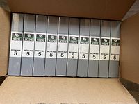 Top view inside open box showing 10 Fuji Betacam 5 H321E videocassettes with gray cases, each labeled H321E and Betacam 5.