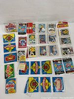 Overview of assorted packs and loose cards laid out showing various brands and years.