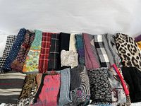 Photo showing 21 assorted scarves and shawls arranged in two rows with various patterns including houndstooth, floral, plaid, pure colors, animal print, and stripes.