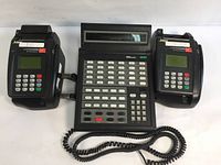 Image showing Tone Commander 1560 Centracom Console Station with two attached handsets, each having a numeric keypad and display screen.