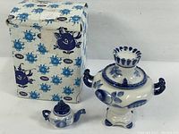 Full view of vintage Gzhel porcelain samovar-shaped urn and miniature teapot with original box