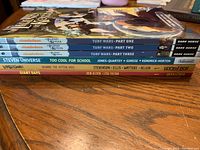 Stack of comic books including The Legend of Korra Turf Wars Part One, Two, Three, Steven Universe: Too Cool For School, Lumberjanes: Beware the Kitten Holy, and Giant Days.