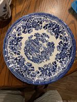 Large plate with blue floral border and central copper engraving style scene of a building and nature