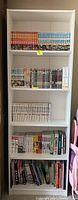 Front view of full bookcase filled with manga books to illustrate shelf usage and size.