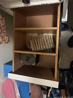 Photo of the inside of the white vanity showing shelves with items stored inside