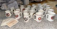 Overview of all 16 brewery ceramic tanker mugs and informational cards.