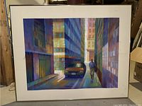 Framed pastel painting of an urban scene showing a car and man walking, signed by Claire Paisner.
