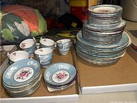 Wide view of stacked plates and loose cups