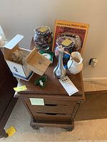 Top-down photo of lot items including boxed chrome candy dish, Lenox cream and sugar, porcelain rabbit and potpourri bowl, pewter vase, Waterford crystal decanter