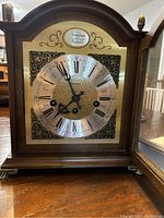 Close-up photo of the clock face showing the name 'Tempus Fuoit' and 'Bulova' with Roman numerals and ornate hands.