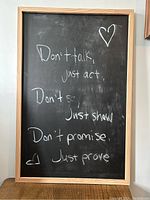 Front view of the framed blackboard with chalk writing on it.